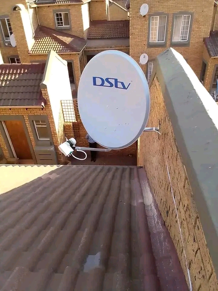 DStv installation — wall-mounted dish with smart LNB, aligned for full signal