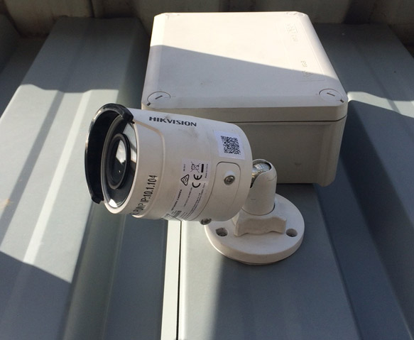 CCTV system — IP bullet camera and weatherproof junction box on a roof edge